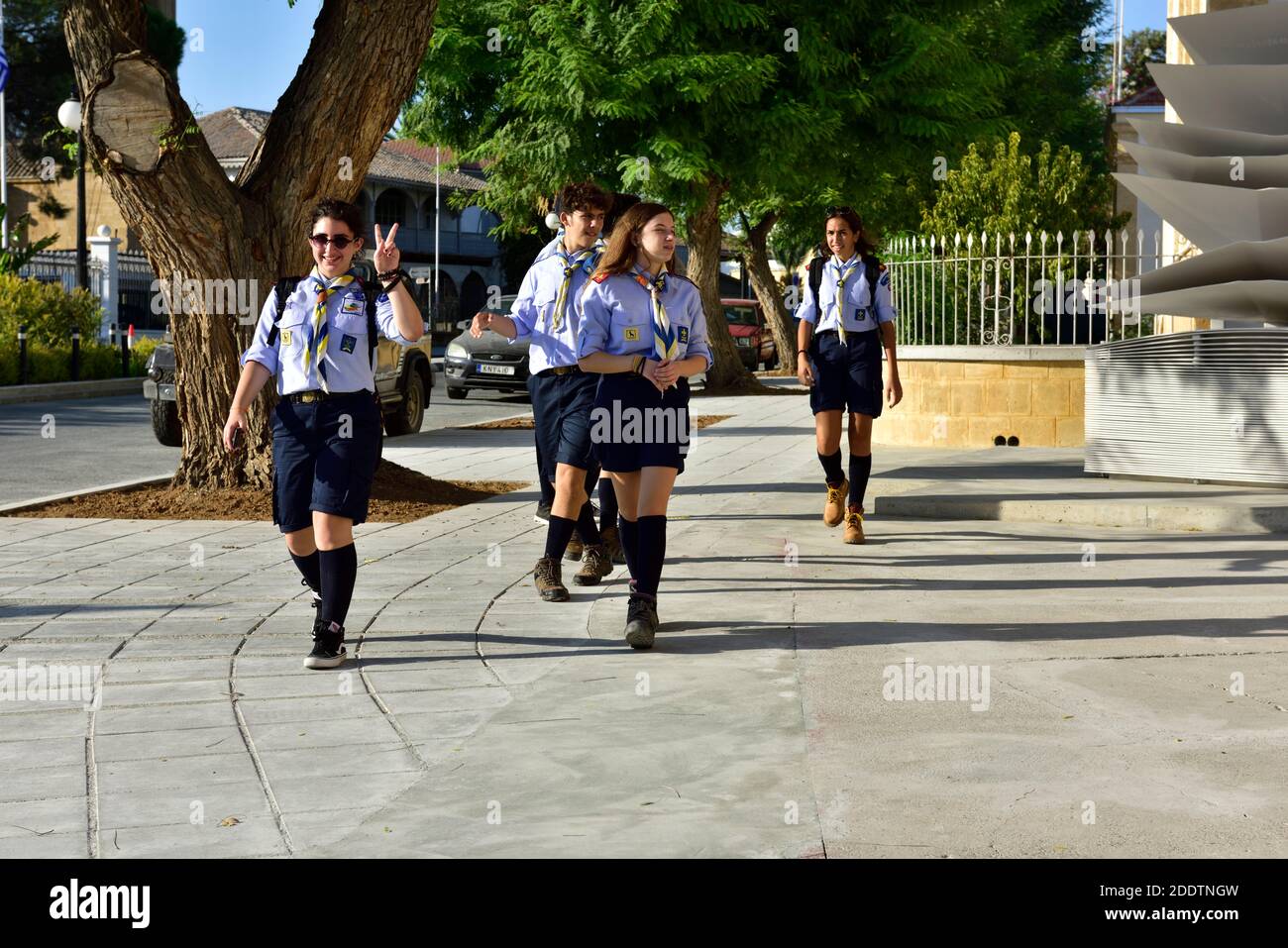 Boy and girl scouts in uniform, with neckerchief and badges going home after scout meeting, Cyprus Stock Photo