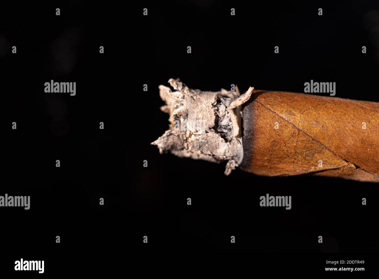 Burning cigar on black background close up Stock Photo Alamy