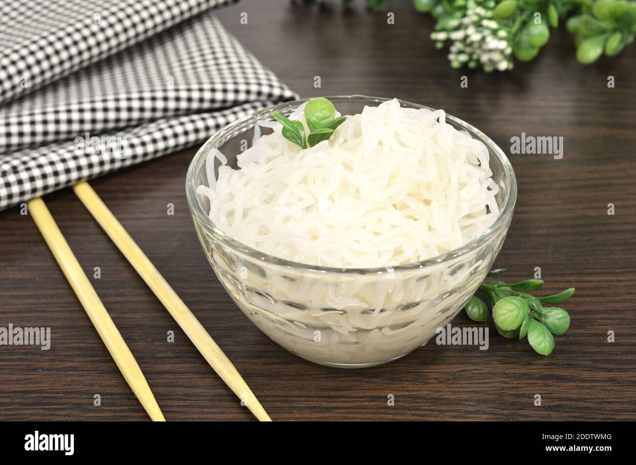 Konjac or Shirataki noodles with Chinese chopsticks. Japanese traditional dish. Healthy food for weight loss, keto diet concept Stock Photo