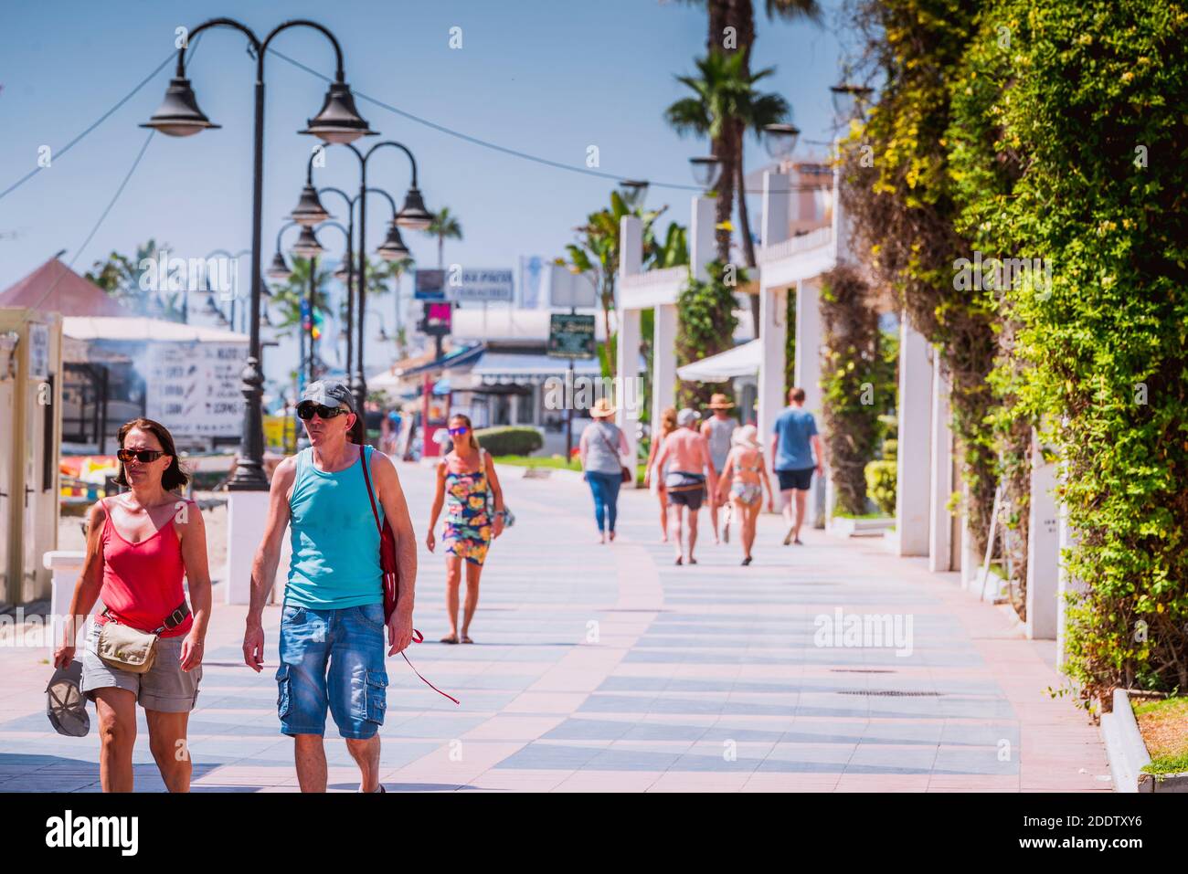 Tourists on the seafront. Paseo Maritimo de La Carihuela - Promenade. La Carihuela, Torremolinos, Málaga, Costa de SOl, Andalucia, Spain, Europe Stock Photo