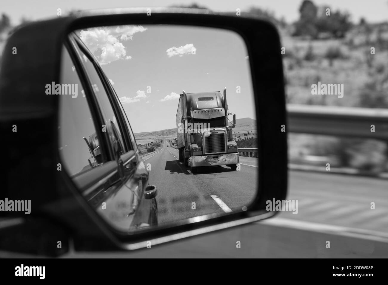 Close up black and white of a truck through the rear view mirror - Trip across California Stock Photo