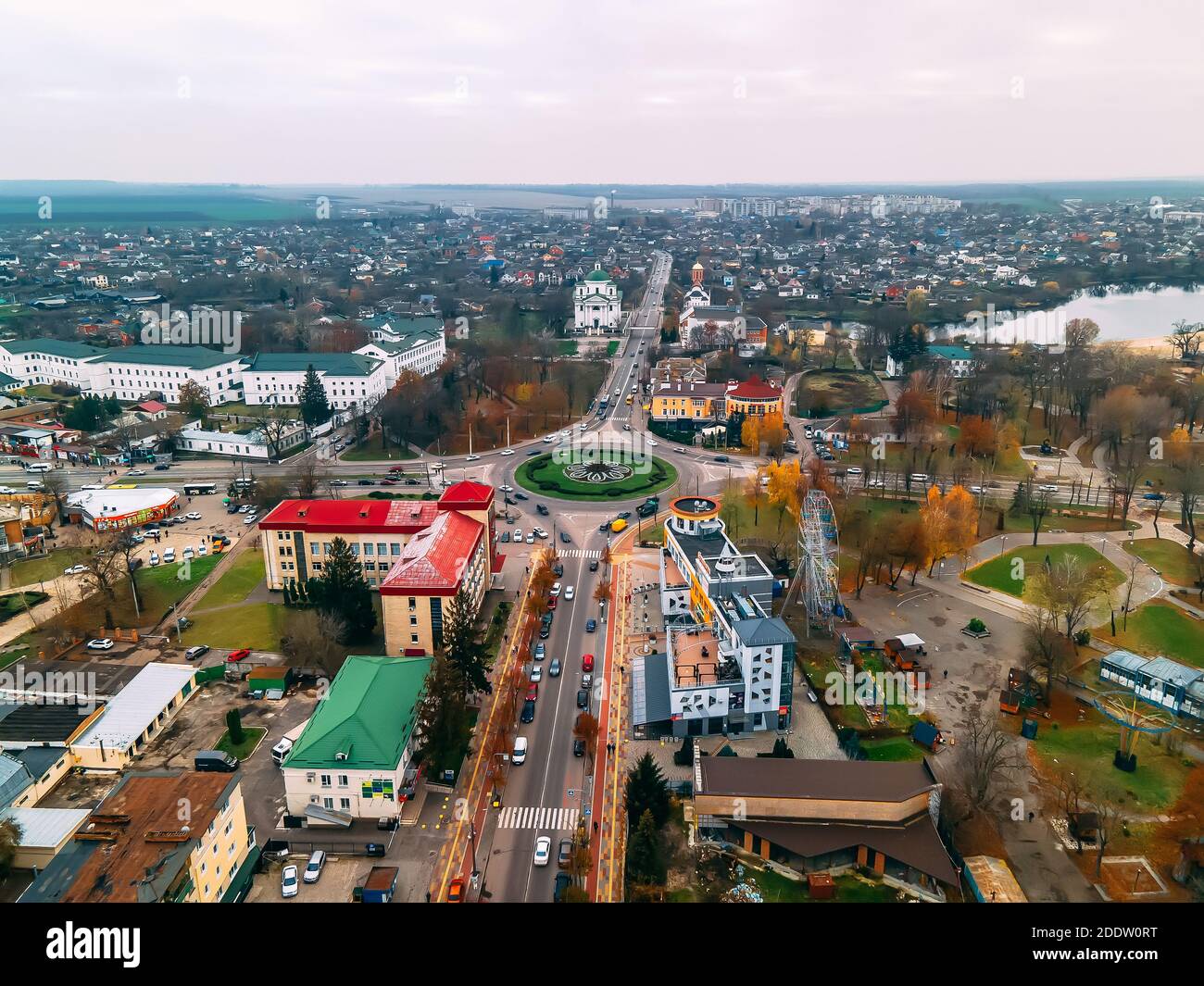 Aerial view of roundabout road with circular cars in small european city at autumn cloudy day, Kyiv region, Ukraine Stock Photo