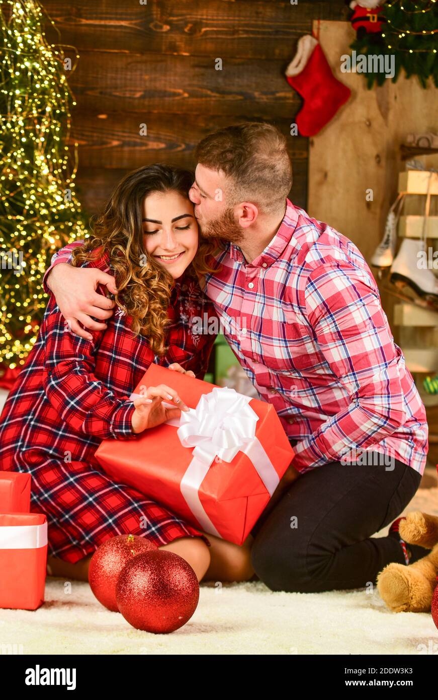 Christmas time. Celebrate new year at home. Spread love. Happy woman and man. Holiday gift. Holiday mood. Couple in love making surprise for each other. Family time. Happiness and joy. Best holiday. Stock Photo