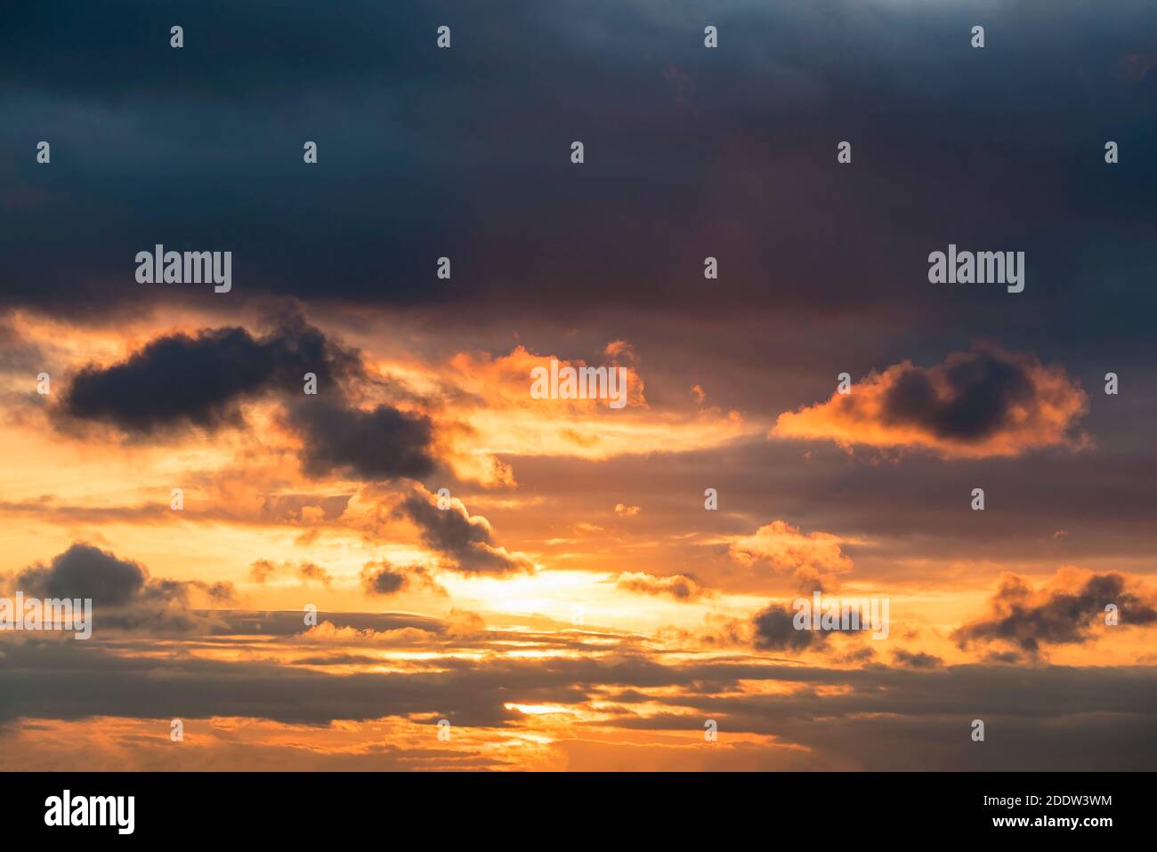 The sky is leaden with dark orange clouds at sunset Stock Photo