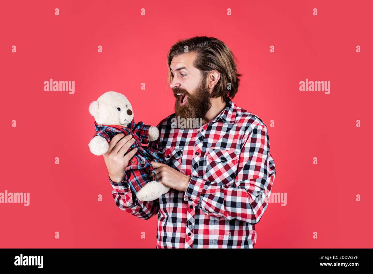 Bearded and stylish. happy valentines day. surprised bearded man hold teddy bear. male feel playful with bear. brutal mature hipster man play with toy. happy birthday. being in good mood. Stock Photo