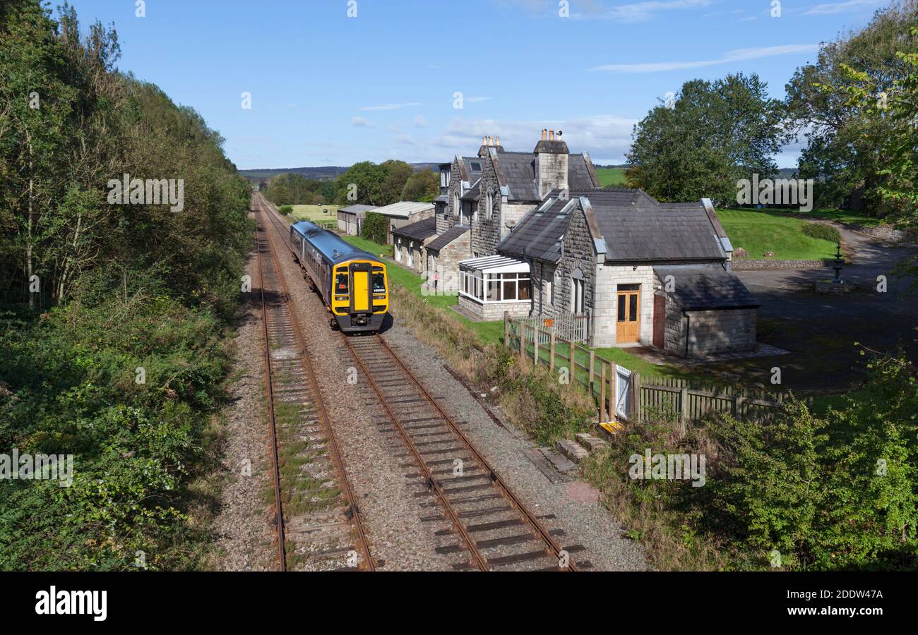 Northern rail class 158 train passing the Closed Arkholme railway station, Lancashire on the 'little north western railway ' line, Lancashire. Stock Photo