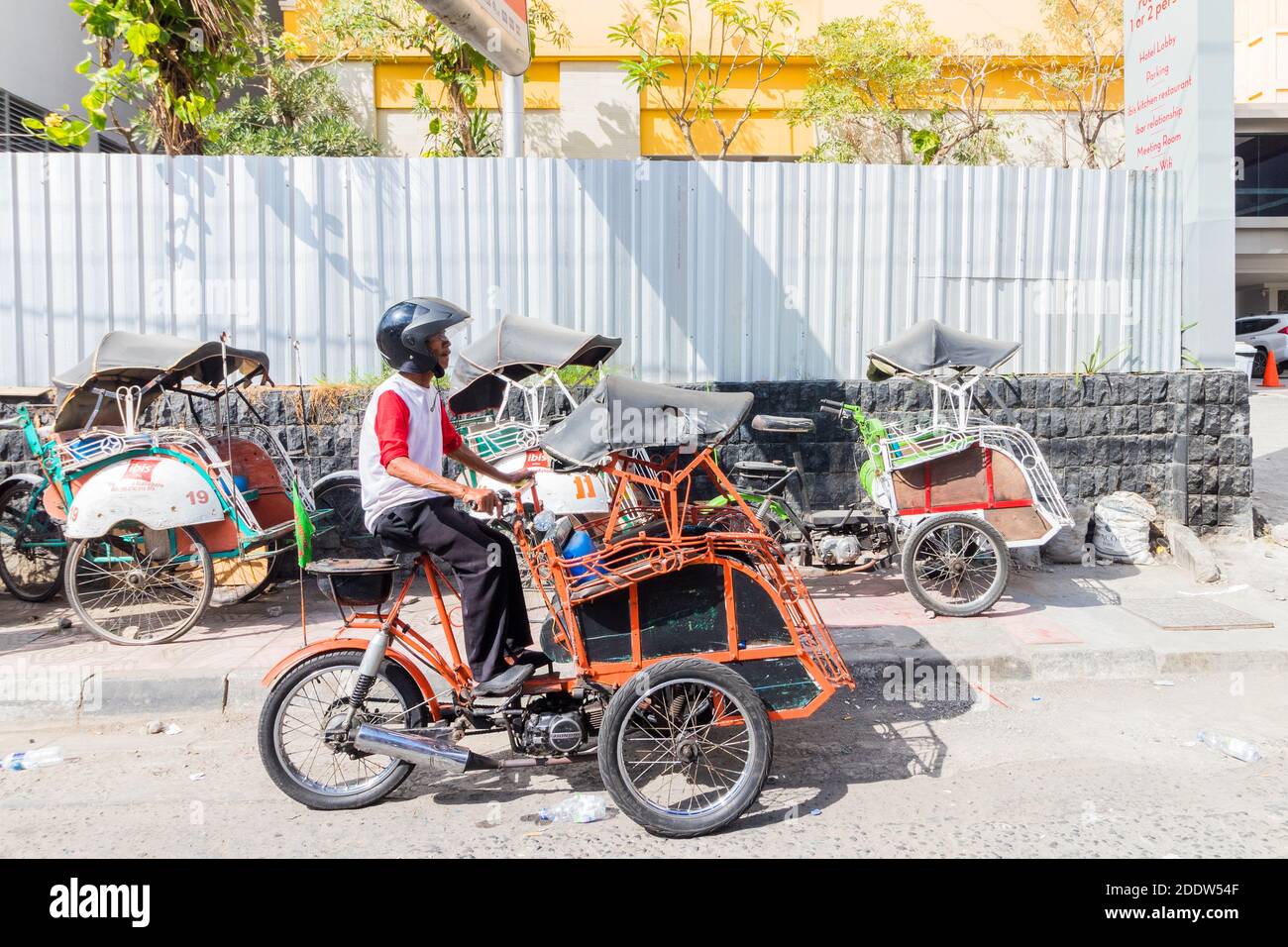 Local tricycle transport called 'becak' at a street in Yogyakarta, Indonesia Stock Photo