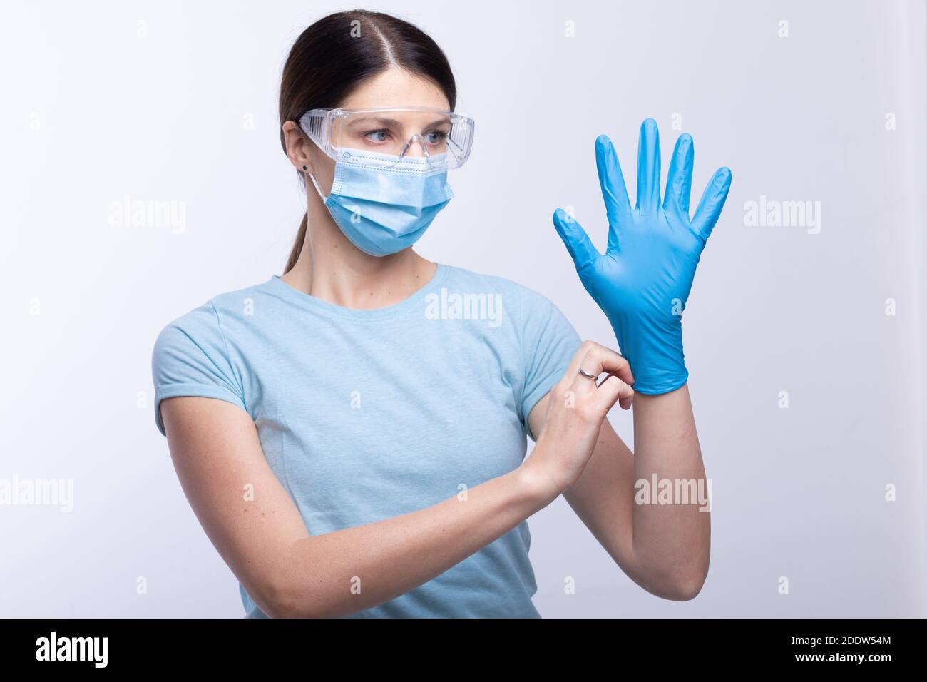 Nurse or doctor wearing and checking protective equipment against viruses and bacterial disease stock photo Stock Photo