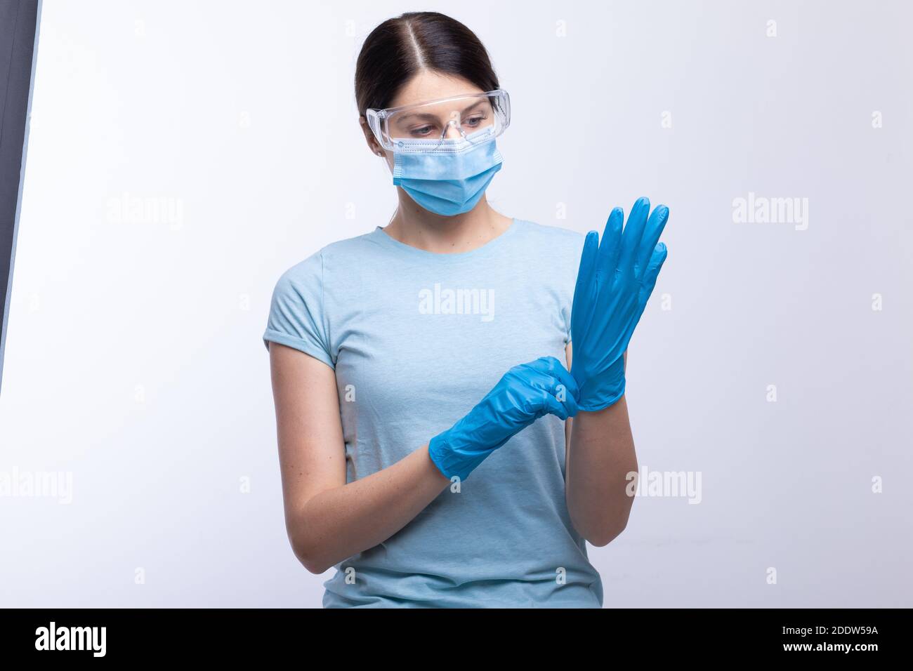 Nurse or doctor wearing and checking protective equipment against viruses and bacterial disease stock photo Stock Photo