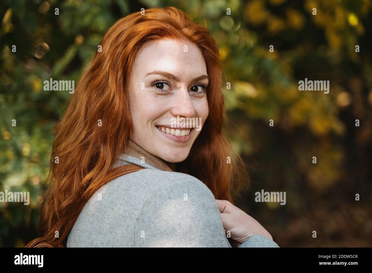 Portrait of young red haired woman during autumnal season Stock Photo