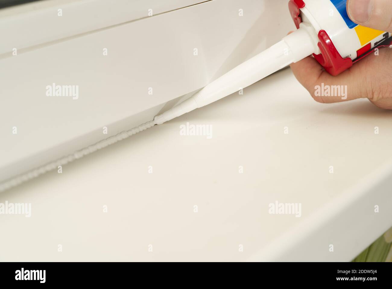 nozzle from which the silicone sealant flows, sealing the gap between Stock Photo Alamy