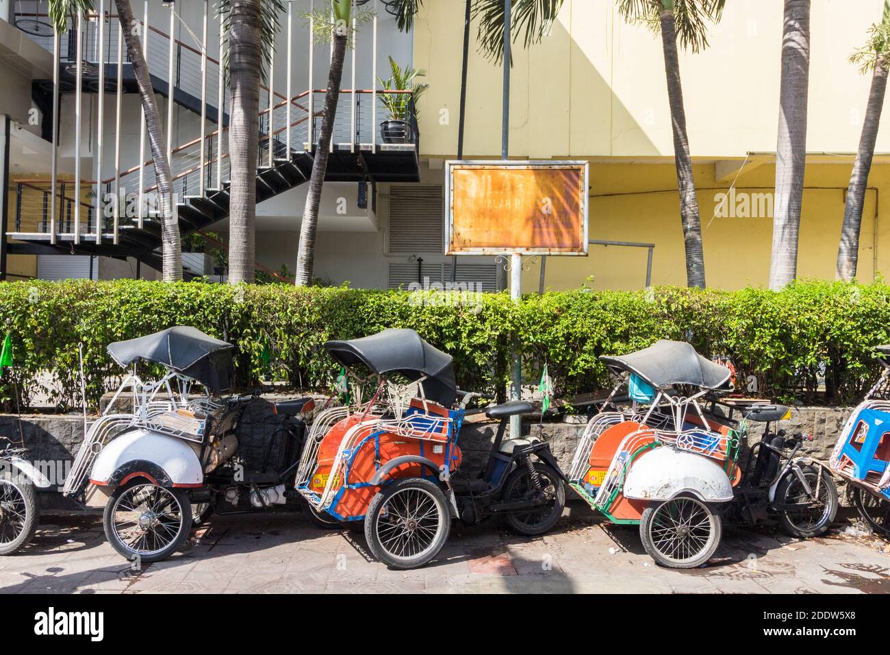Local tricycle transport called 'becak' at a street in Yogyakarta, Indonesia Stock Photo