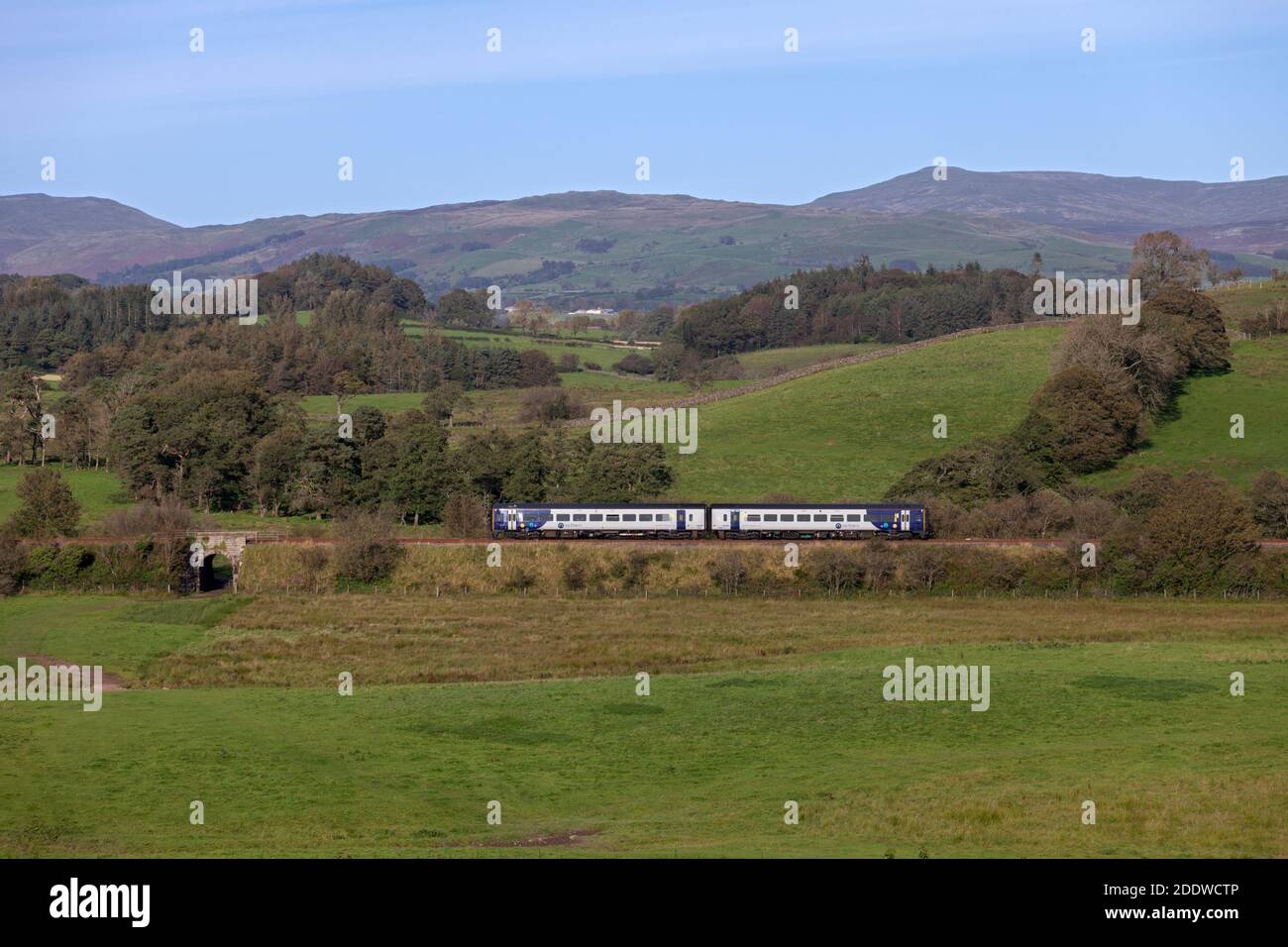 Northern Rail class 158 diesel train on the rural 'little north western' railway passing the north Lancashire countryside at Arkholme Stock Photo