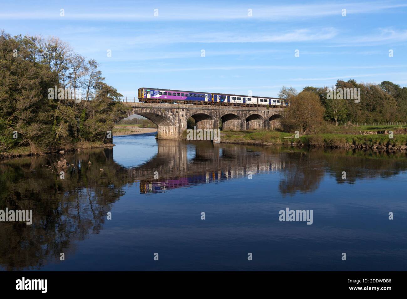 Northern Rail class 153 +150 train crossing the river Lune viaduct at Arkholme on the ' little north western ' line in Lancashire Stock Photo