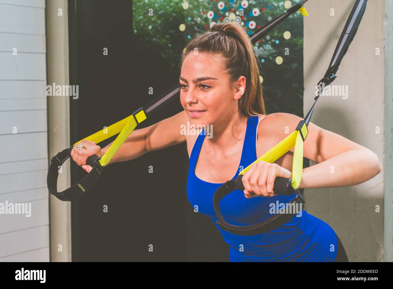 Beautiful girl training her arms with straps Trx Fitness in the gym - Woman  doing push-ups trains the upper body chest shoulders pectoral triceps Stock  Photo - Alamy
