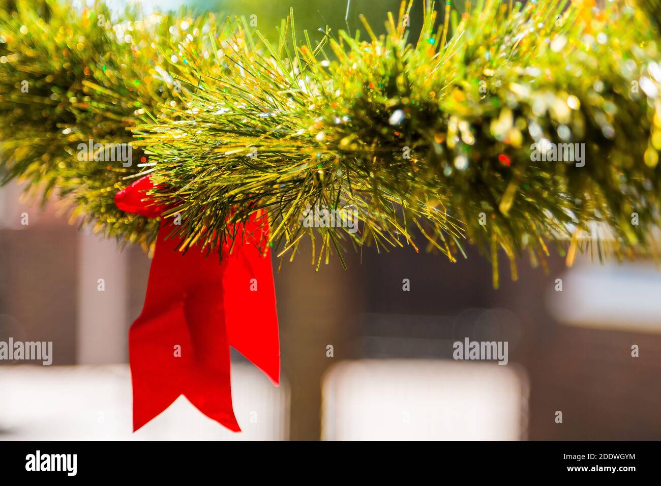 Closeup shot of a green wreath with a Christmas ribbon Stock Photo