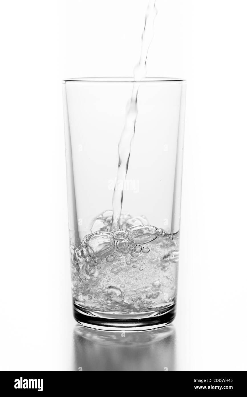 Pouring sparkling water into a glass. A container for storing liquids
