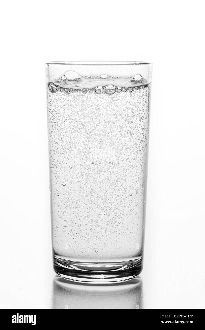 A glass filled with sparkling water. A container for storing liquids