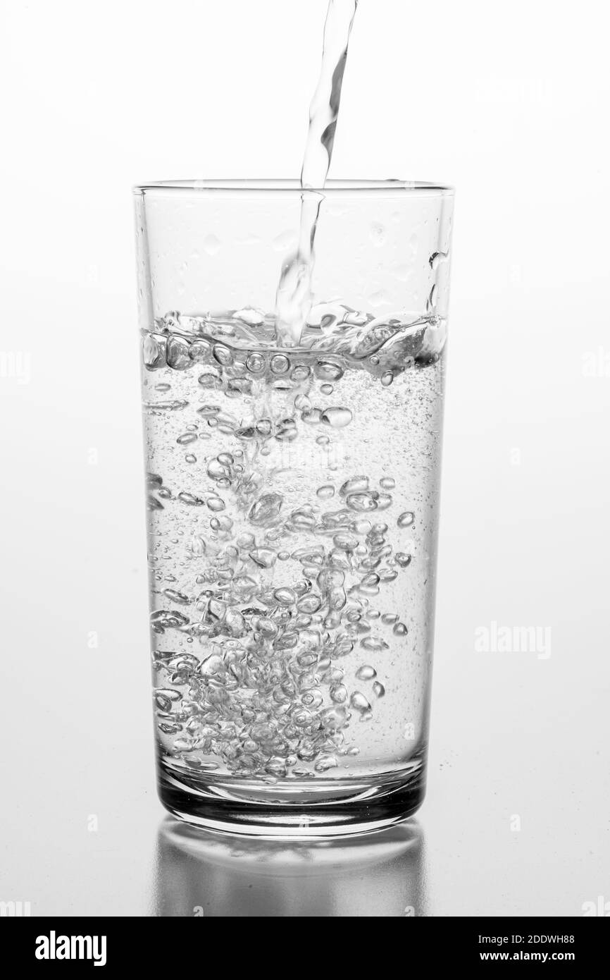 Pouring sparkling water into a glass. A container for storing liquids