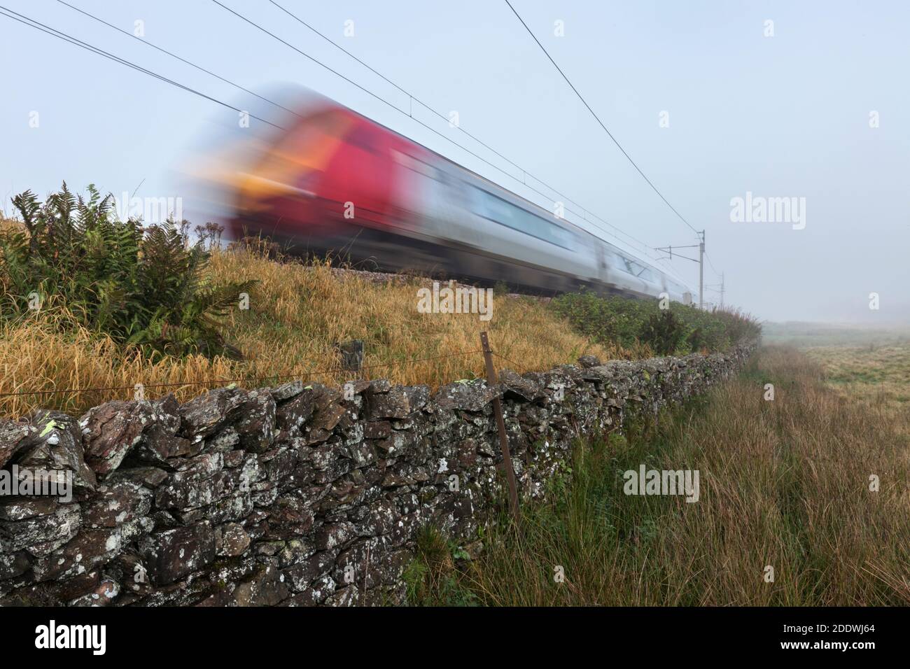 Avanti west coast Bomabrdier voyager diesel trains speeding along  the west coast mainline passing the Cumbrian countryside with motion blur Stock Photo