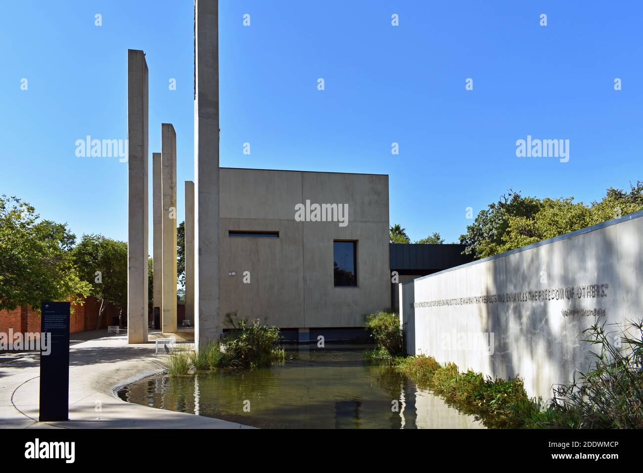 The Pillars of the Constitution, an exhibition in the Apartheid Museum in Johannesburg, South Africa. A small pond in front of the concrete building. Stock Photo