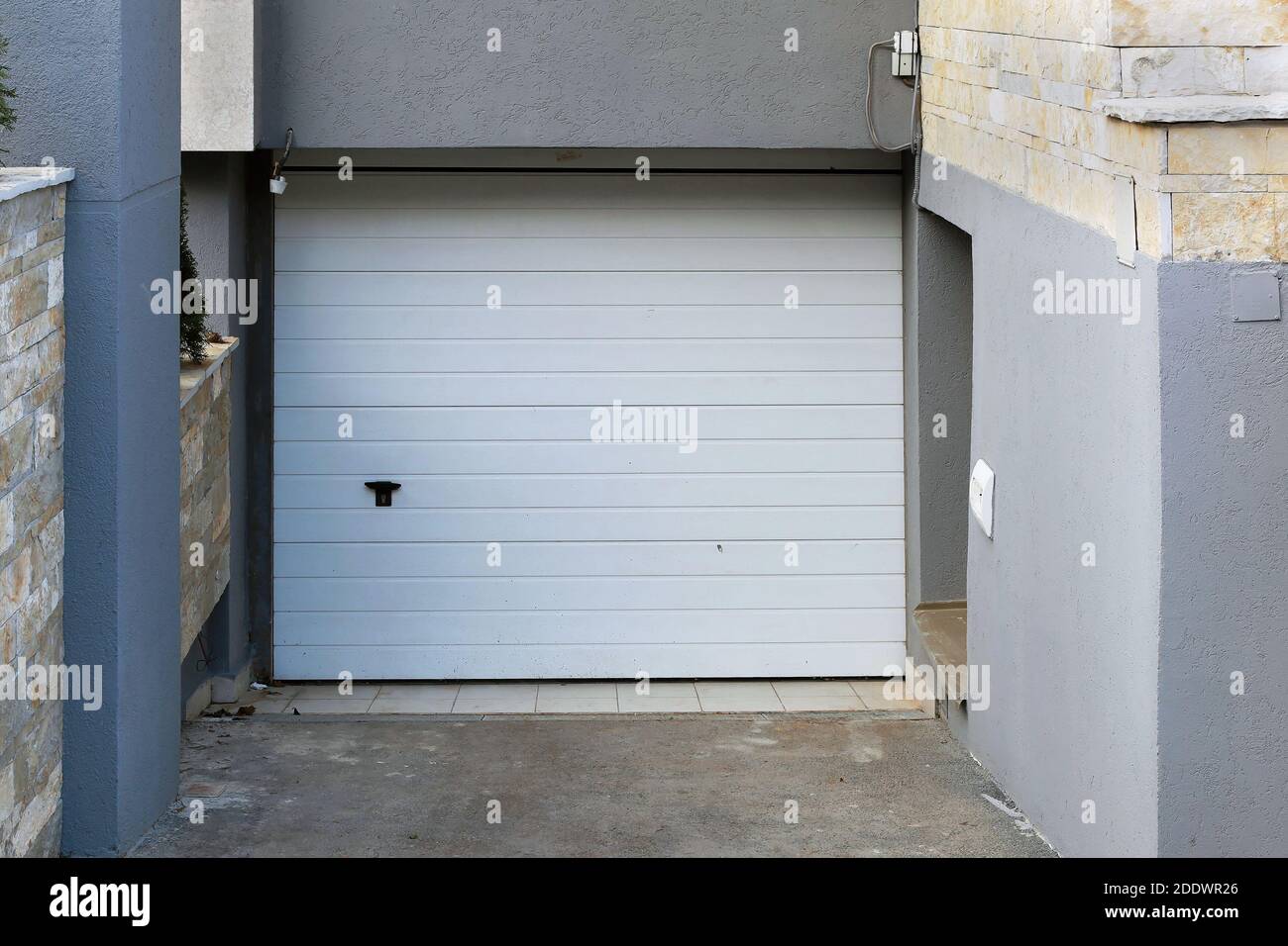 Garage closed entrance door exterior outside modern house Stock Photo