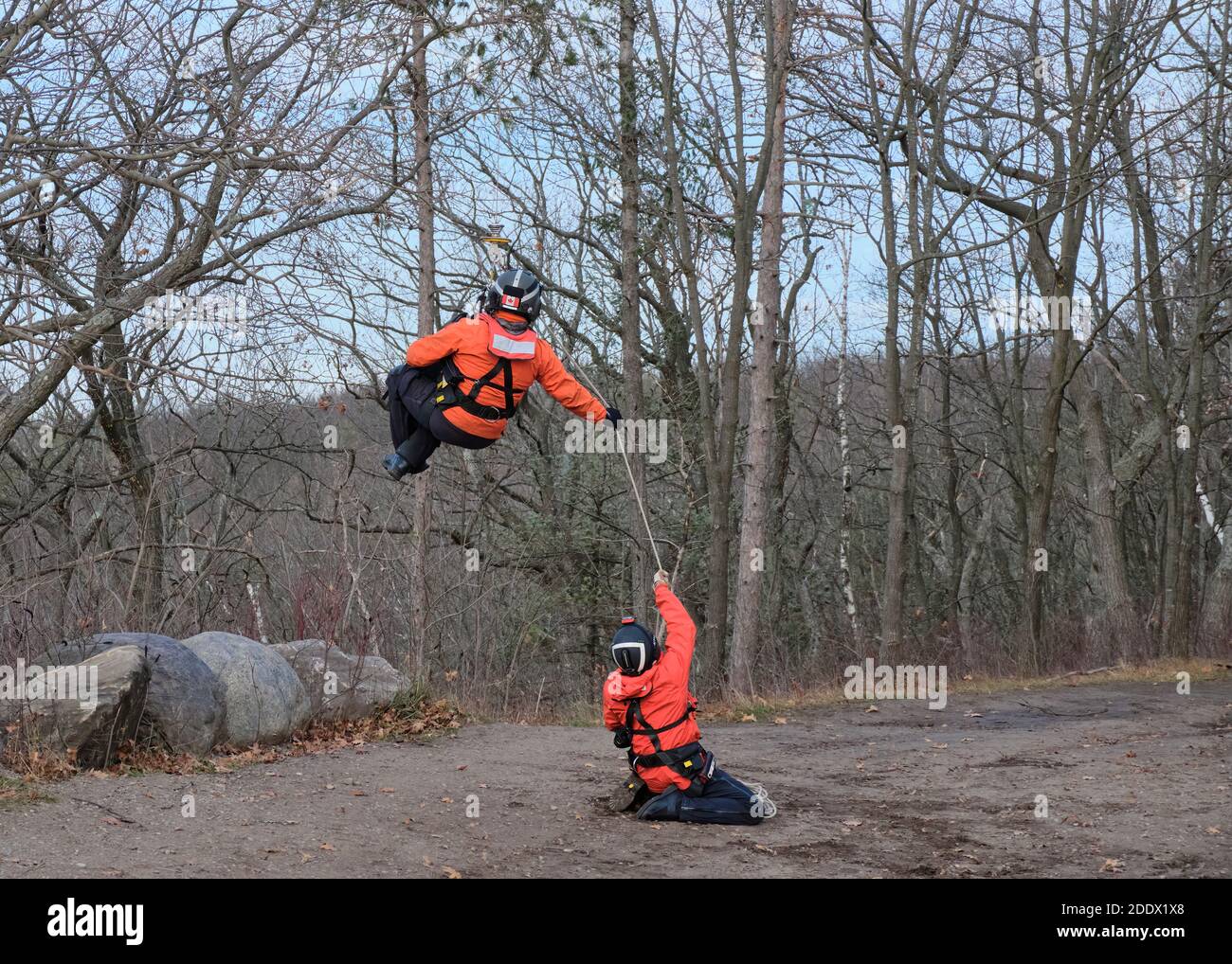 Northumberland County Forest, Ontario, Canada - November 19, 2020: A close-up of two Search and Rescue Technicians working as a team, as one is hoiste Stock Photo