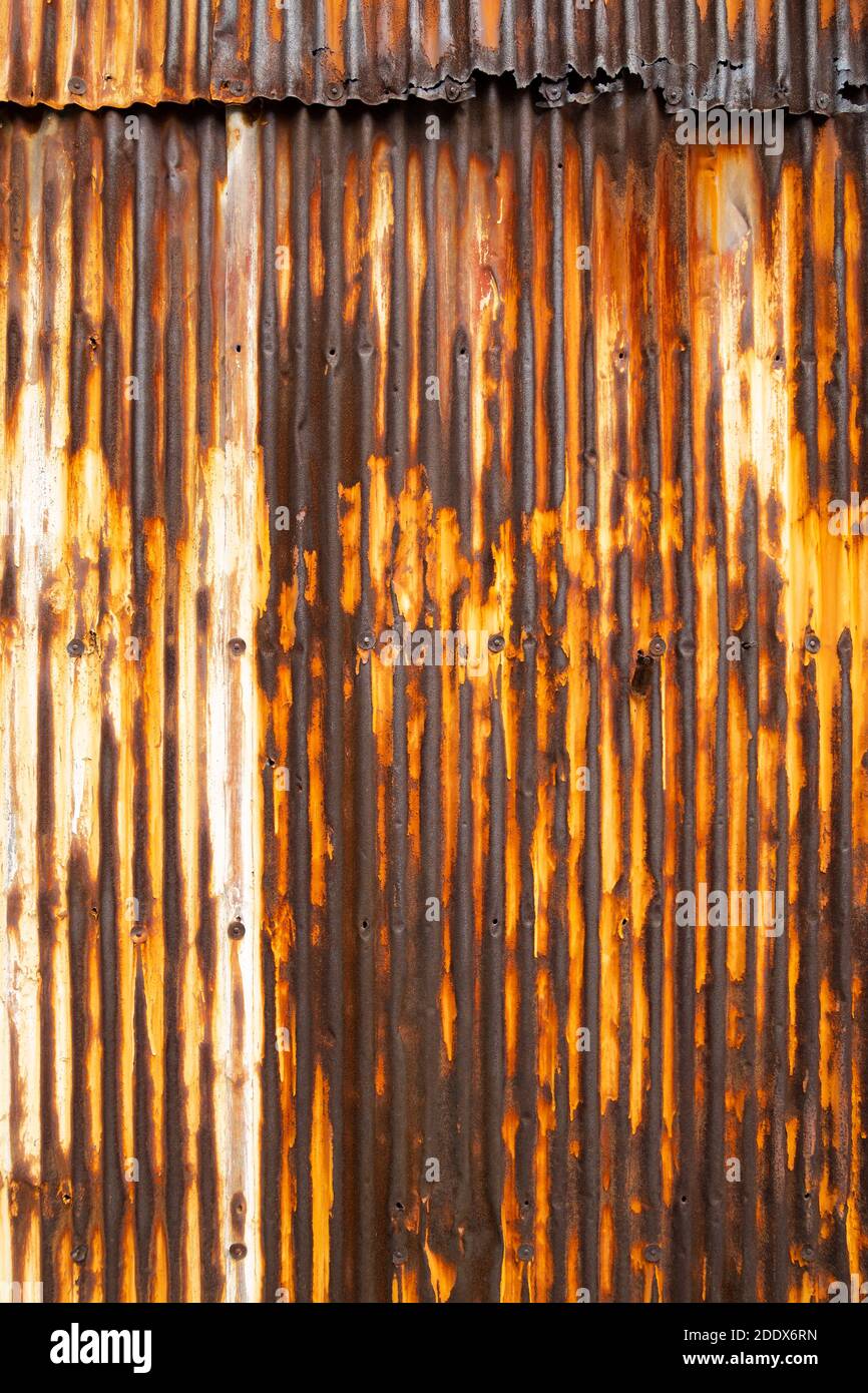 Old rusty wavy metal plate wall background Stock Photo - Alamy