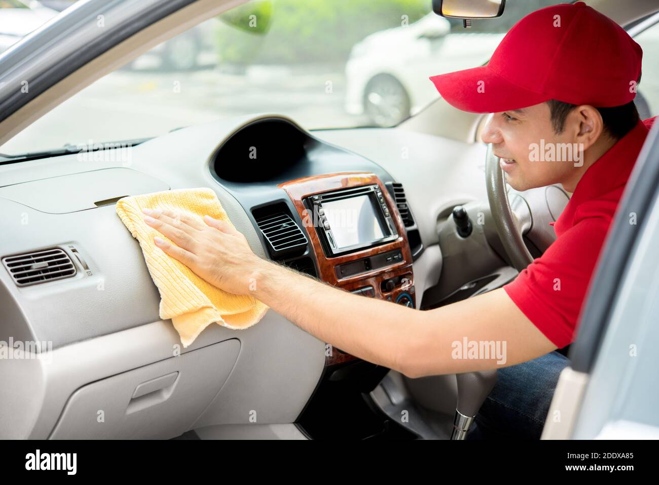 Auto service staff cleaning car interior - car detailing and valeting concept Stock Photo