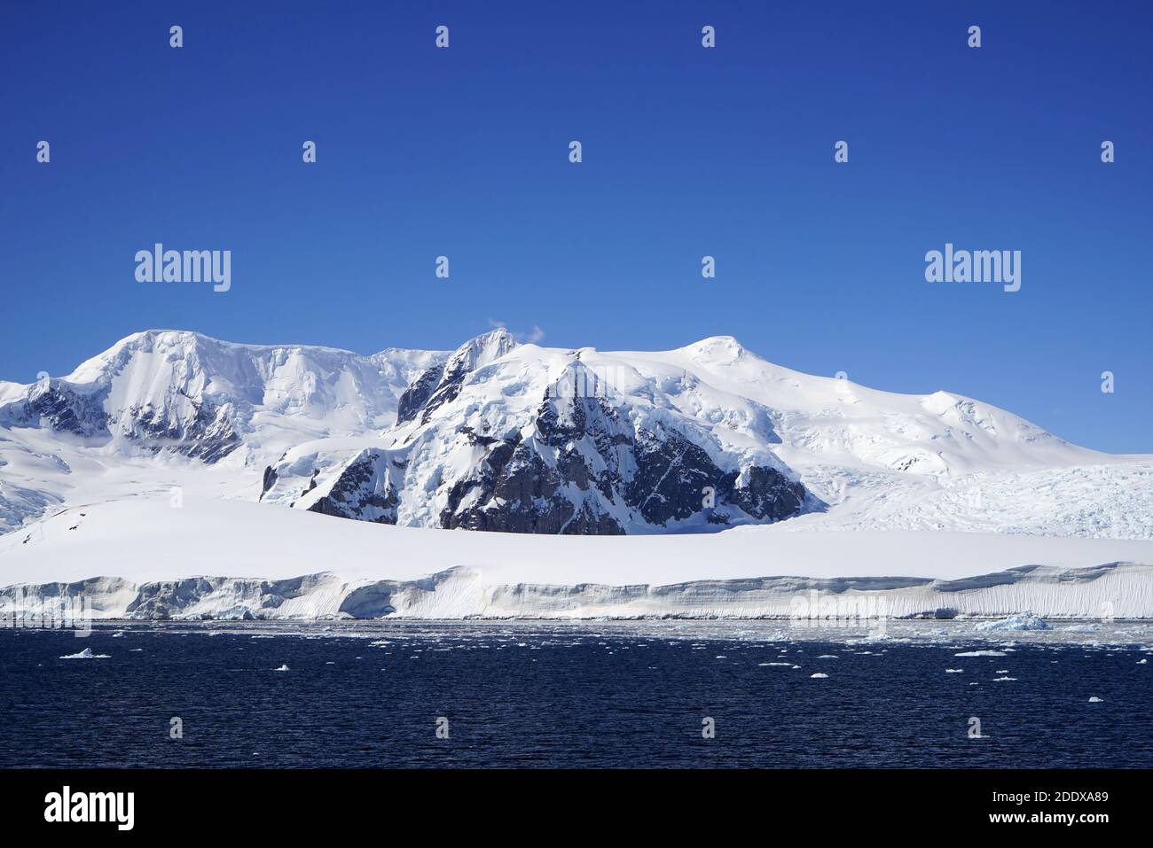 Iceberg With Rocks There is a big rock in the center of the iceberg Stock Photo - Alamy