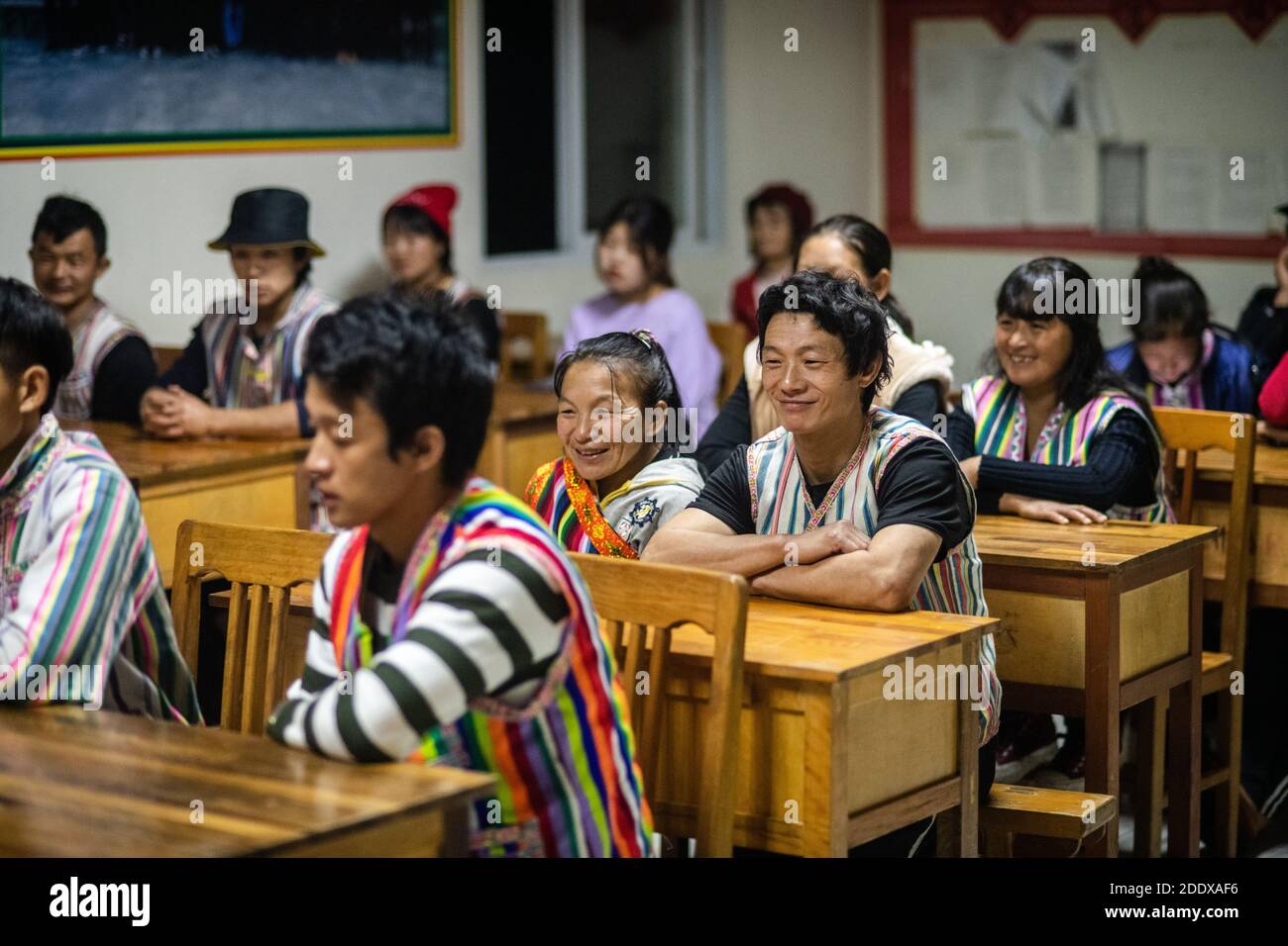 (201127) -- KUNMING, Nov. 27, 2020 (Xinhua) -- Dulong villagers attend an evening lesson in Kongdang Village of Dulongjiang Township, Gongshan Dulong and Nu Autonomous County, southwest China's Yunnan Province, Oct. 28, 2020. Dulong is a mountain-dwelling ethnic group in southwest China. It is one of the least populous of China's 56 minority nationalities. It is also called a 'direct-transition' minority ethnic group because the Dulong people didn't bid farewell to primitive life until the founding of the People's Republic of China in 1949 and since then they directly stepped into the sociali Stock Photo