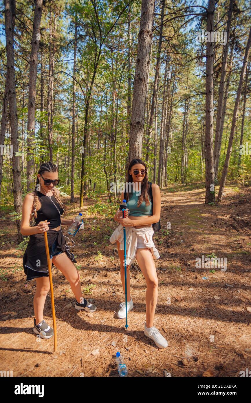 Two female caucasian friends hiking in the woods on a mountain on a ...