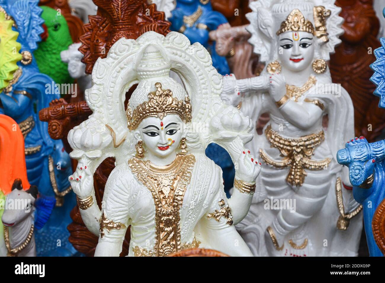 Many colorful statue sculptures of Hindu god, lord Krishna in an street shop, Delhi, India. popular Indian divinity worshiped celebrated as Janmashtam Stock Photo