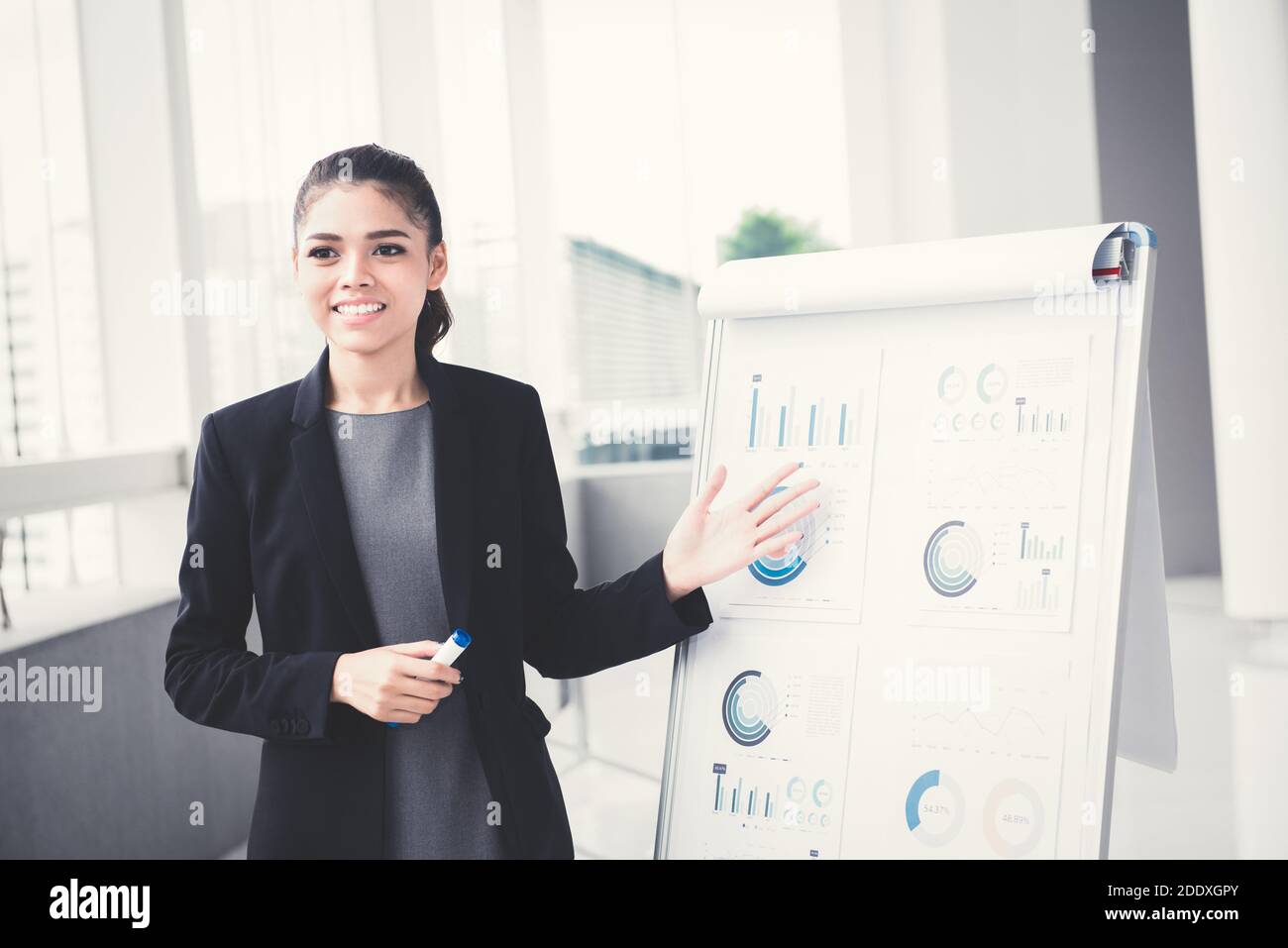 Young businesswoman presenting her work with flip chart Stock Photo