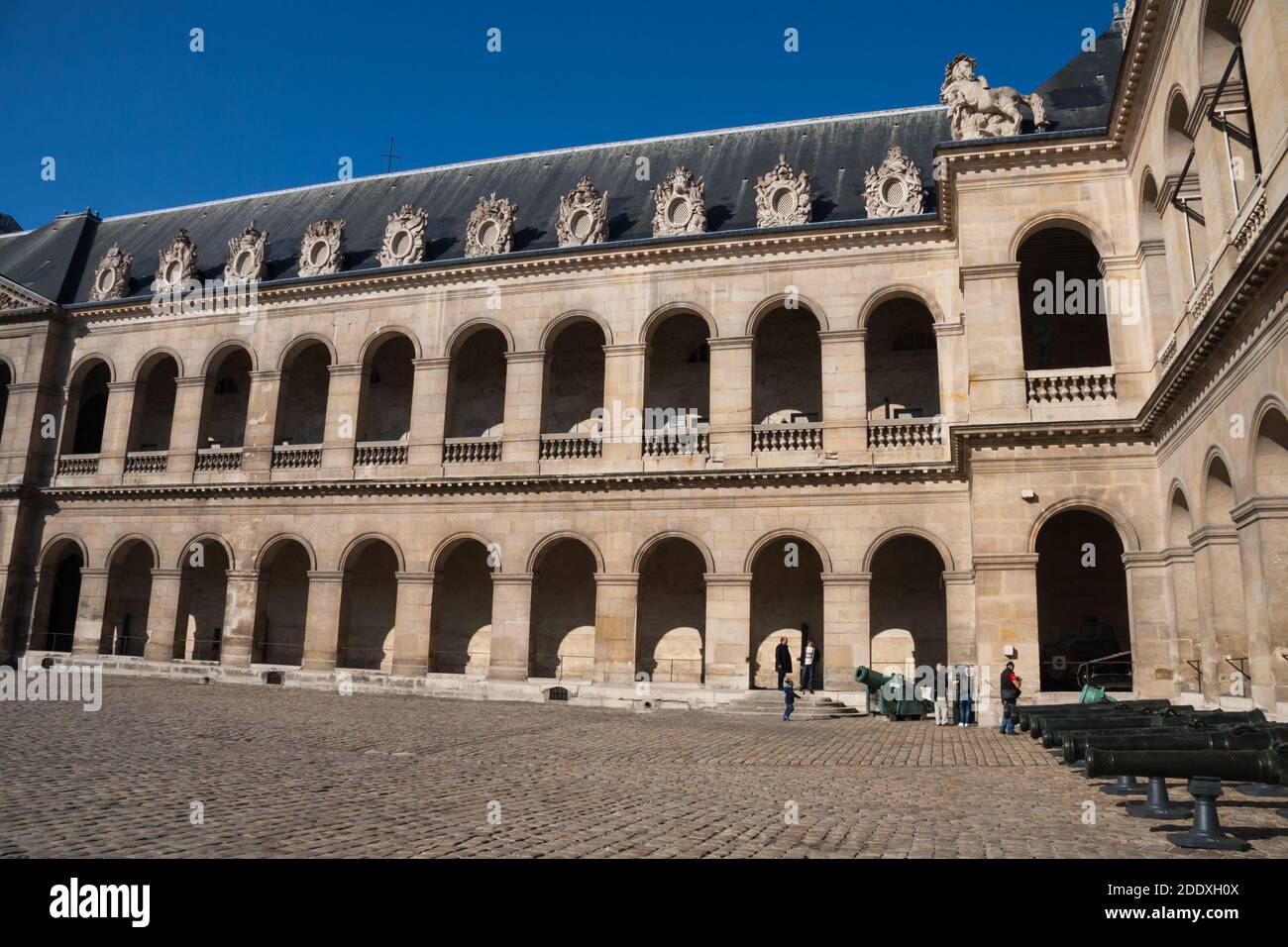 Paris, France Sept 27 2015: Courtyard at Hotel les Invalides (Invalids Residence) and the Army Museum with tourists and cannons. Stock Photo