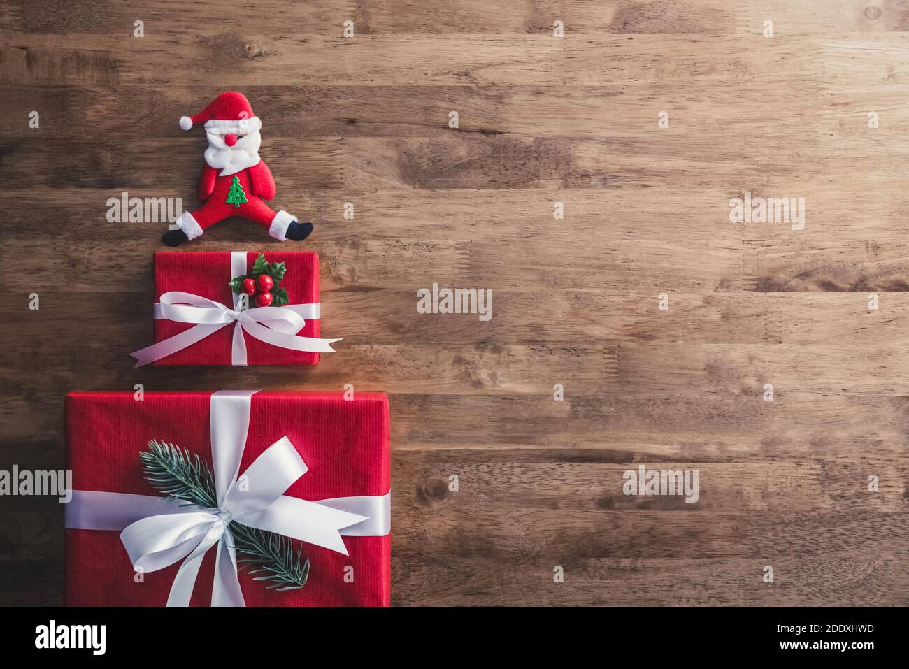 Lovely red Christmas gift boxes and decorated items on wood  background, top view with copy spce Stock Photo