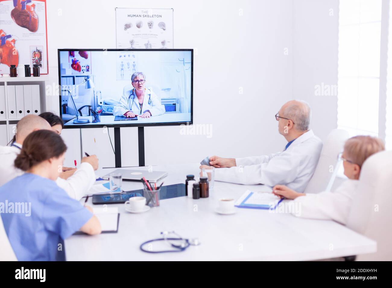 Group of doctors listening medical expert during video call in