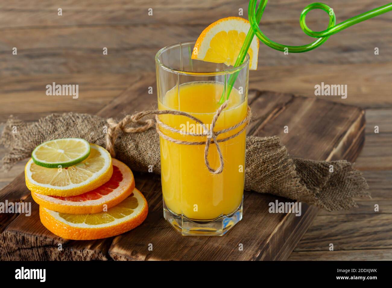 Glasses of juice and citrus fruits on a wooden table. Rustic style Stock Photo