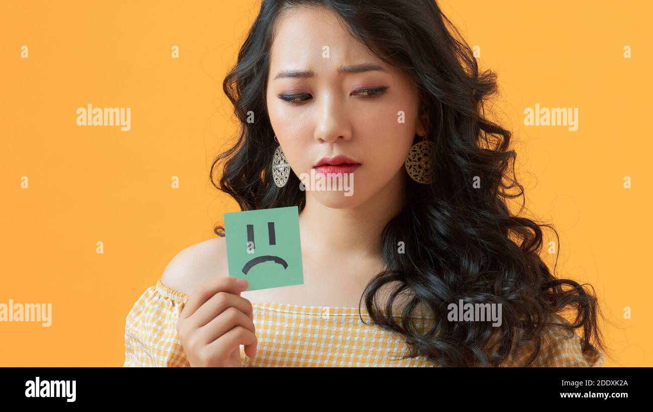 Photo of sad upset lady hold paper sticker emoticons frustrated  isolated over shine color background Stock Photo