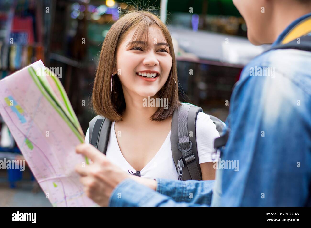 Smiling Asian female tourist backpacker traveling in Bangkok Thailand on summer holidays Stock Photo