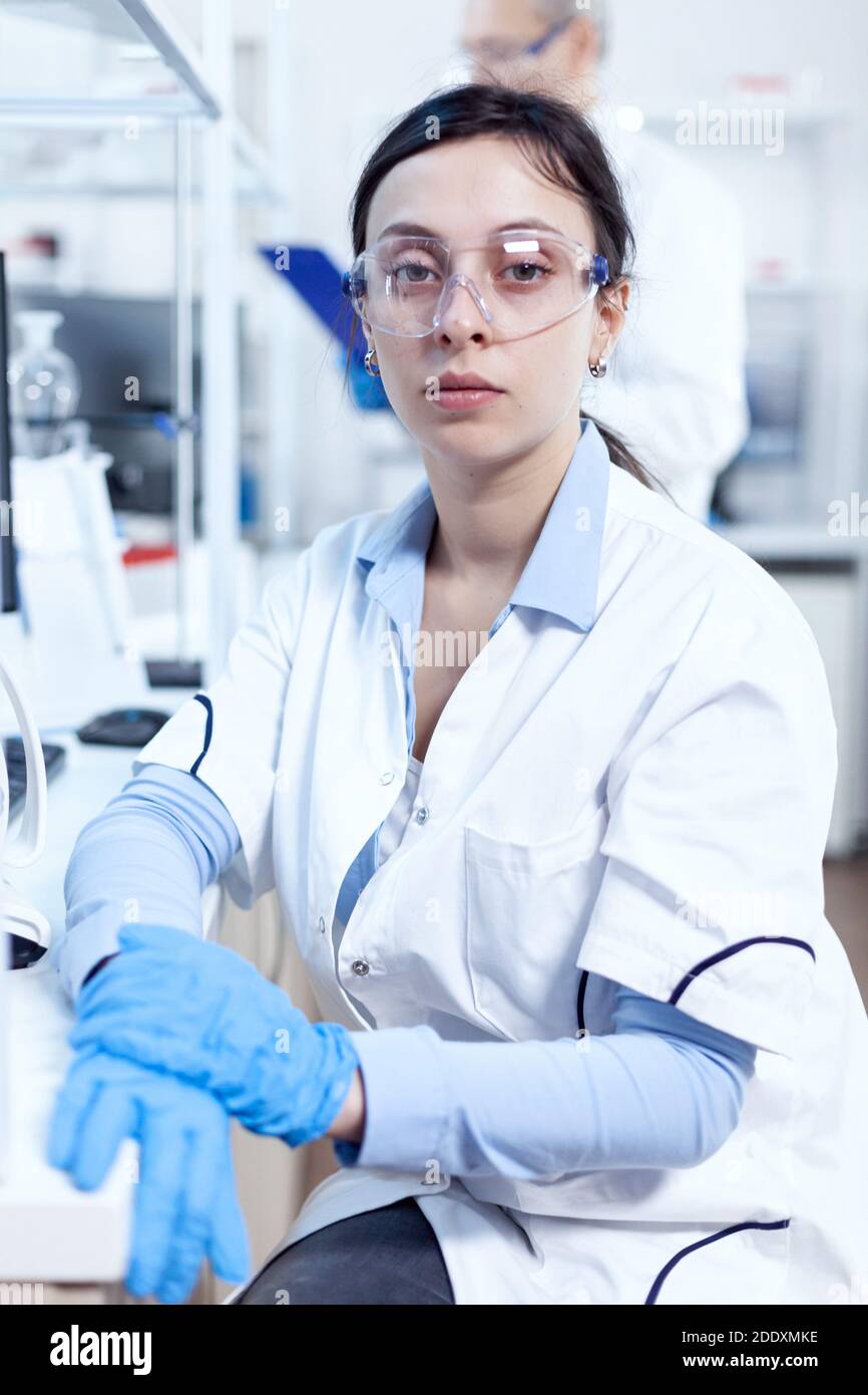 Successful scientist in looking at camera in research