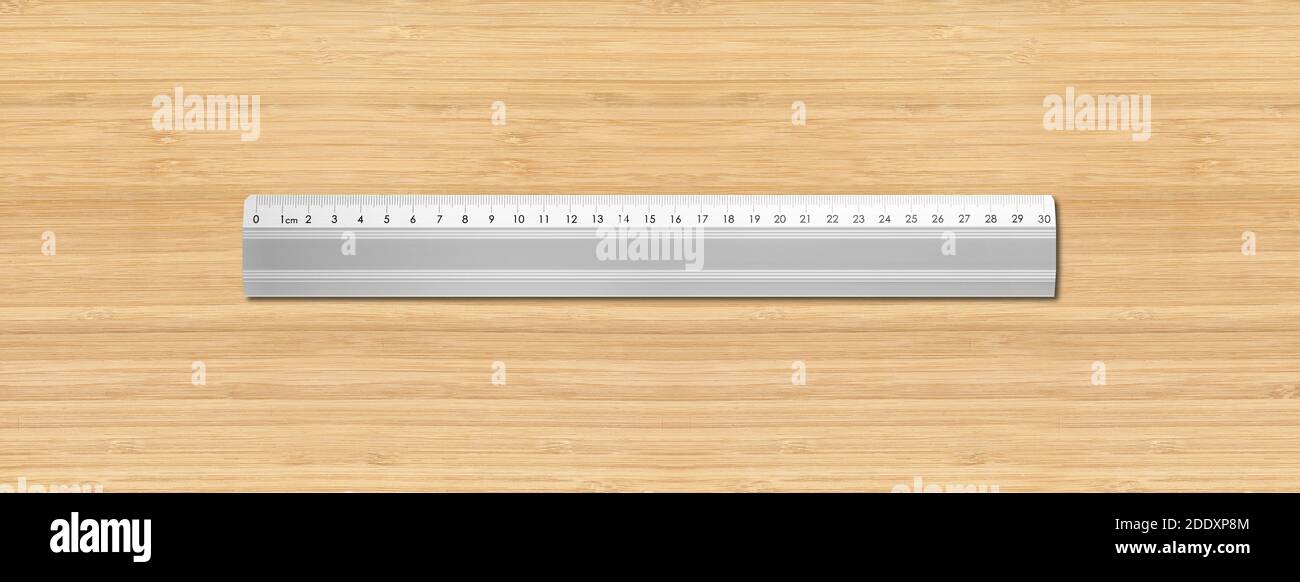 Steel metallic ruler isolated on wooden background Stock Photo - Alamy