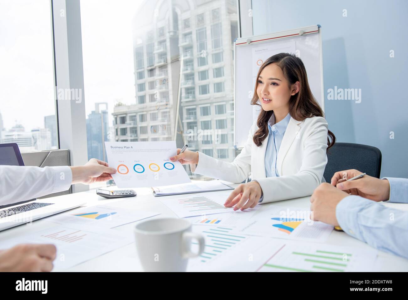 Smart Asian businesswoman having annual meeting with her team at the office in the city Stock Photo
