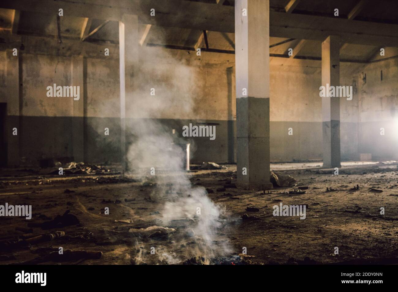 Abandoned old factory Hall scene with smoke and messy interior Stock Photo