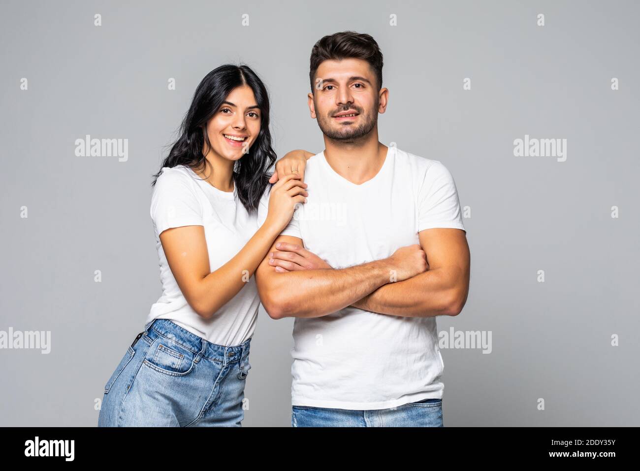Portrait of young couple smiling on white background Stock Photo - Alamy