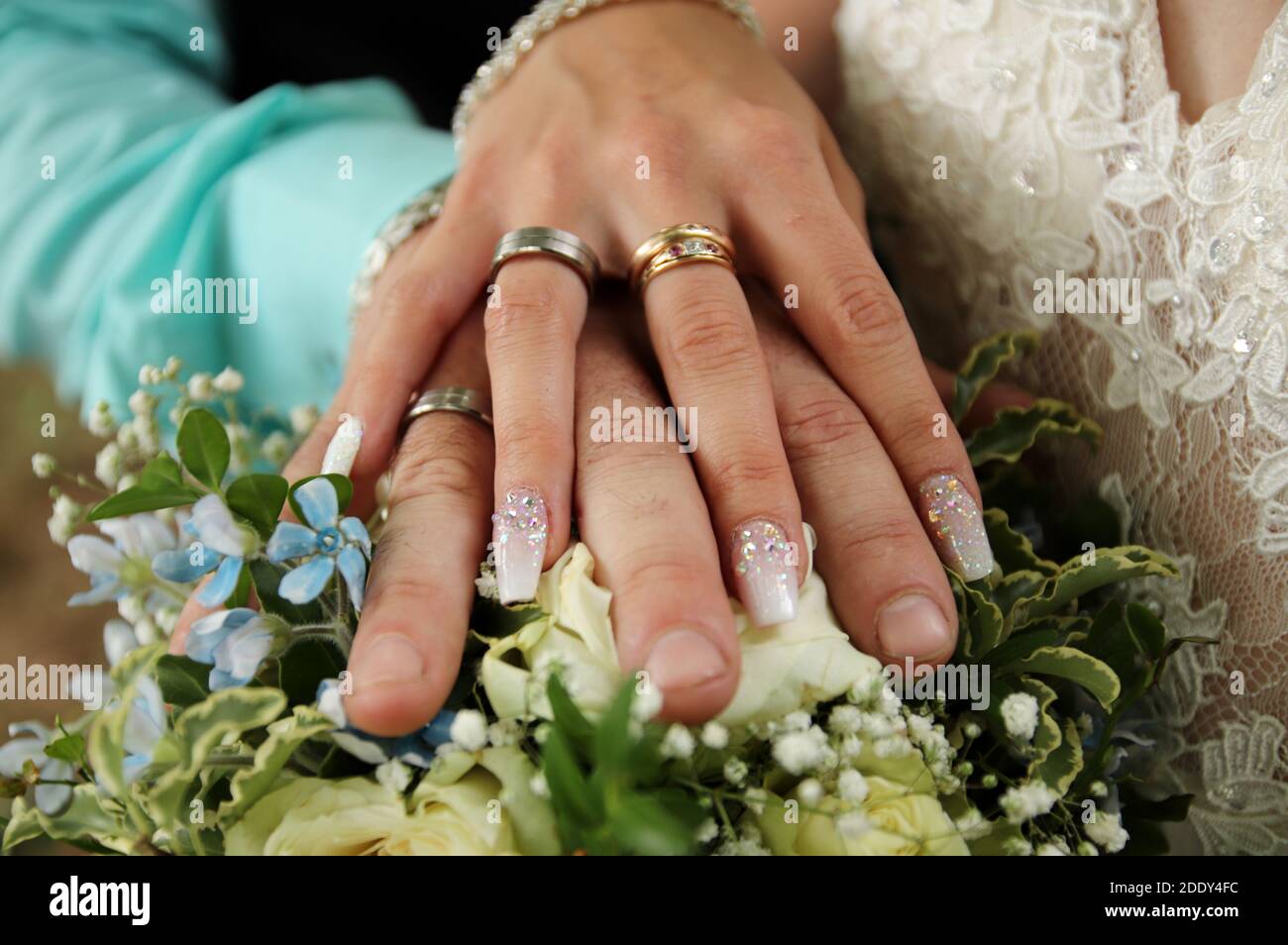 Wedding rings. Hand of the bride with a ring holds a wedding bouquet