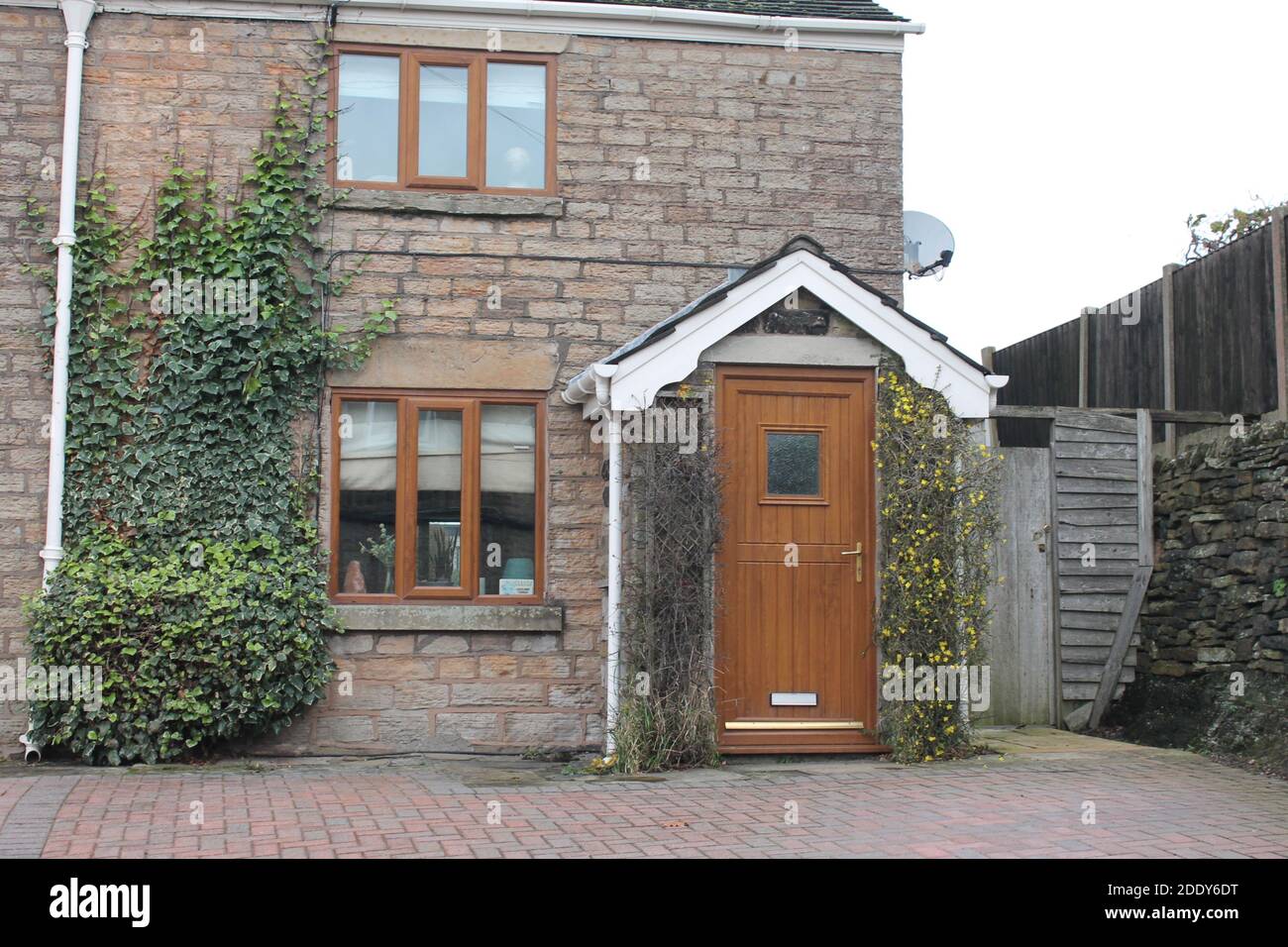 English stone built cottage with block paving driveway Stock Photo