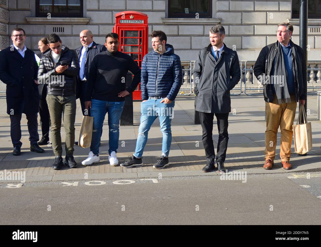 Sir Graham Brady MP [far right] (Con: Altrincham and Sale West) chairman of the 1922 Committee waiting to cross the road in Whitehall Stock Photo