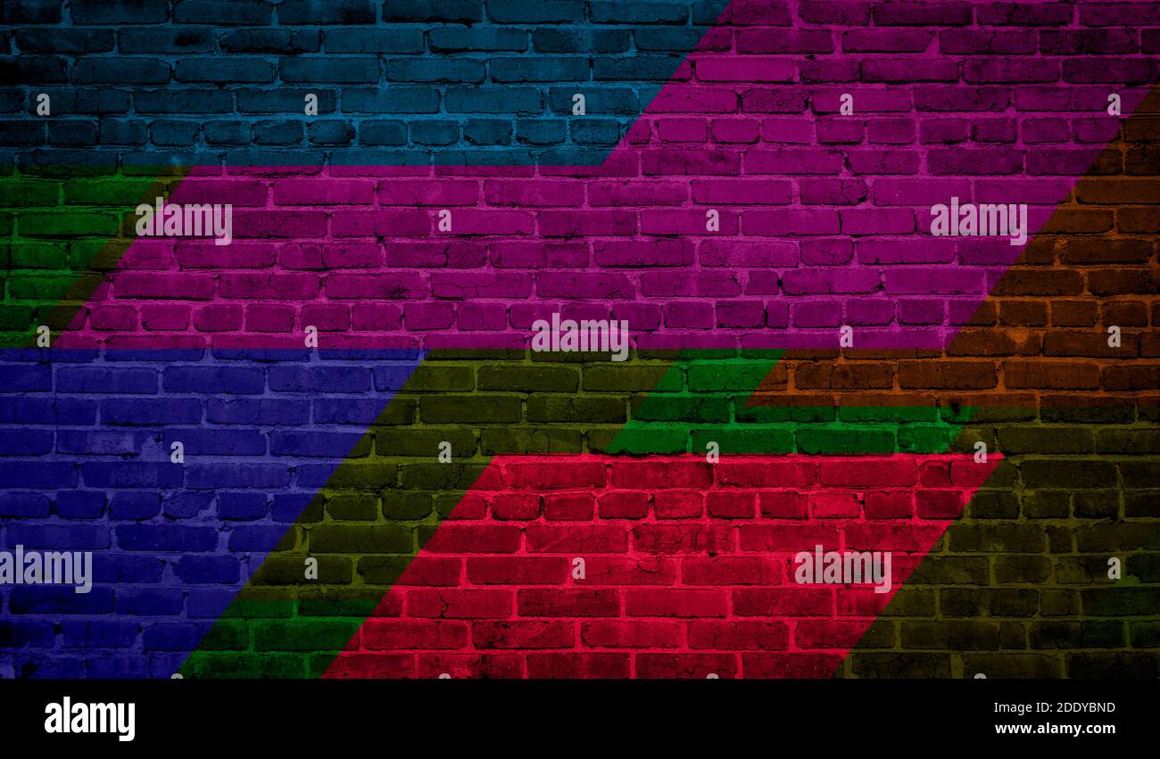 Brick wall painted with multi-colored paints. Abstract background. The old wall. Stock Photo