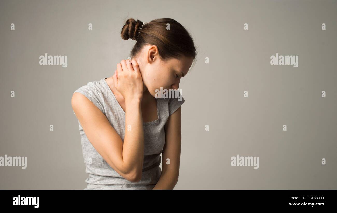 Tired woman feeling pain, massaging tense muscles Stock Photo